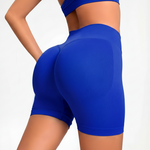 Blue SOFTFORM™ SEAMLESS SHORT worn by a person on a light gray background