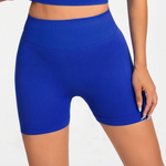 Blue athletic SOFTFORM™ SEAMLESS SHORT shorts worn by a person on a white background