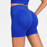 Blue SOFTFORM™ Seamless shorts worn by a person on a light gray background