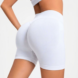 White athletic shorts worn by a person on a light gray background