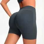 Person wearing dark gray SOFTFORM™ Seamless Shorts  on a light gray background