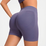 woman wearing purple SOFTFORM™ Seamless Shorts athletic shorts on a plain background