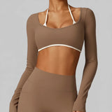 Brown SoftForm™ Long-Sleeve Crop athletic outfit with long sleeves and a sports bra on a light gray background