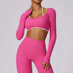 Person wearing a SoftForm™ Long-Sleeve Crop pink athletic outfit on a gray background