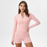 Woman wearing a pink SoftForm™ Long-Sleeve Top and shorts set on a white background