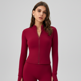 Woman wearing a SoftForm™ Long-Sleeve Top red athletic outfit on a gray background