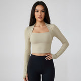 A woman wearing a SoftForm_Long-Sleeve_Yoga_Top_cloud long-sleeve top and black leggings on a plain background