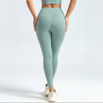 Person wearing light green SoftForm_Sculpt_Leggings leggings on a white background