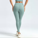Person wearing light green SoftForm_Sculpt_Leggings leggings on a white background