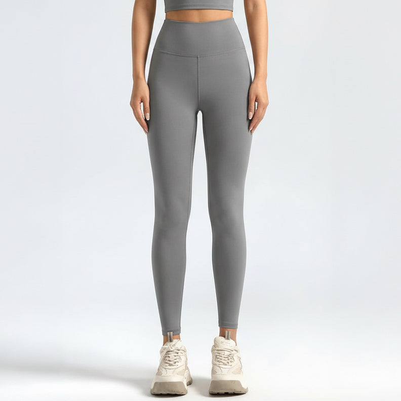 Person wearing gray SoftForm Sculpt Leggings on a white background