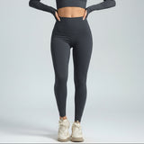 Person wearing stone SoftForm Sculpt_Leggings leggings and a cropped top on a plain background
