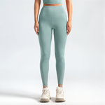 Person wearing light blue SoftForm_Sculpt leggings and a matching top on a white background