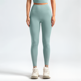 Person wearing light blue SoftForm_Sculpt leggings and a matching top on a white background