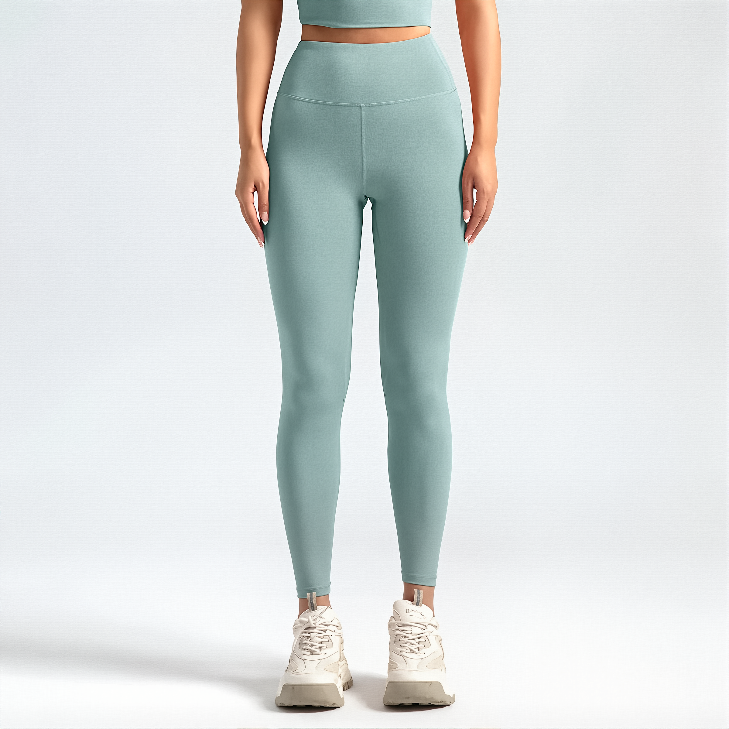 Person wearing light blue SoftForm_Sculpt leggings and a matching top on a white background