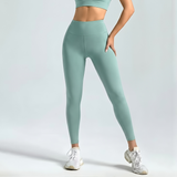 woman wearing light greenSoftForm™ Sculpt Leggings and a matching crop top on a plain background