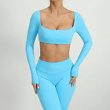 Woman wearing a SoftForm™ Sculpt Tank ash blue athletic outfit on a light gray background