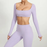 woman wearing a SoftForm™ Sculpt Tank lavender long-sleeve crop top and leggings set on a light gray background