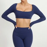 Navy blue athletic outfit with long-sleeve top and leggings on a white background