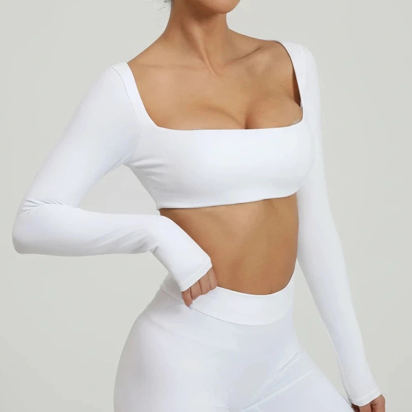 White SoftForm™ Sculpt Tank long-sleeve crop top worn by a person on a plain background