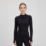 Woman wearing a SoftForm™ Slim Jacket black  athletic top on a light gray background