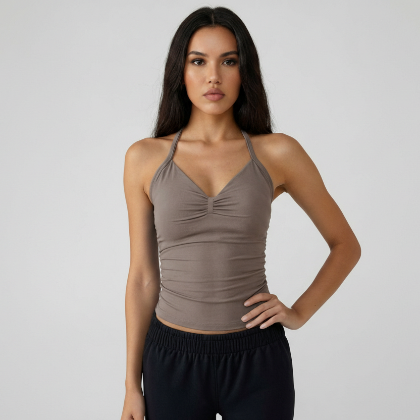 Woman wearing a brown SoftForm™ Tank top and black pants against a plain background