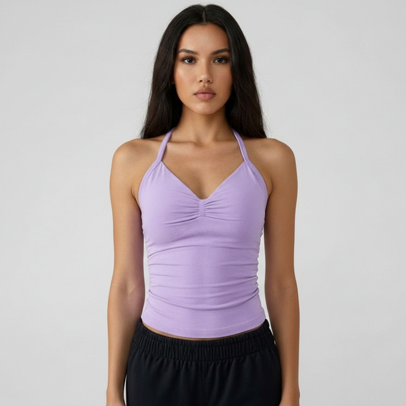 Woman wearing a purple SoftForm™ Tank top and black pants against a plain background