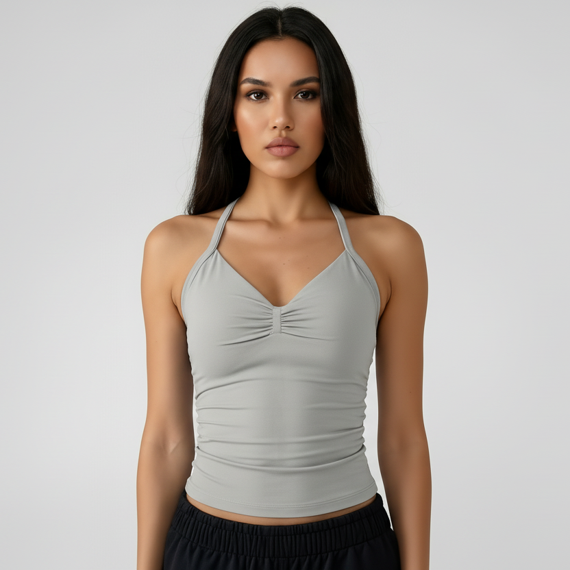 Woman wearing a SoftForm™ Tank_stone top and black shorts on a white background