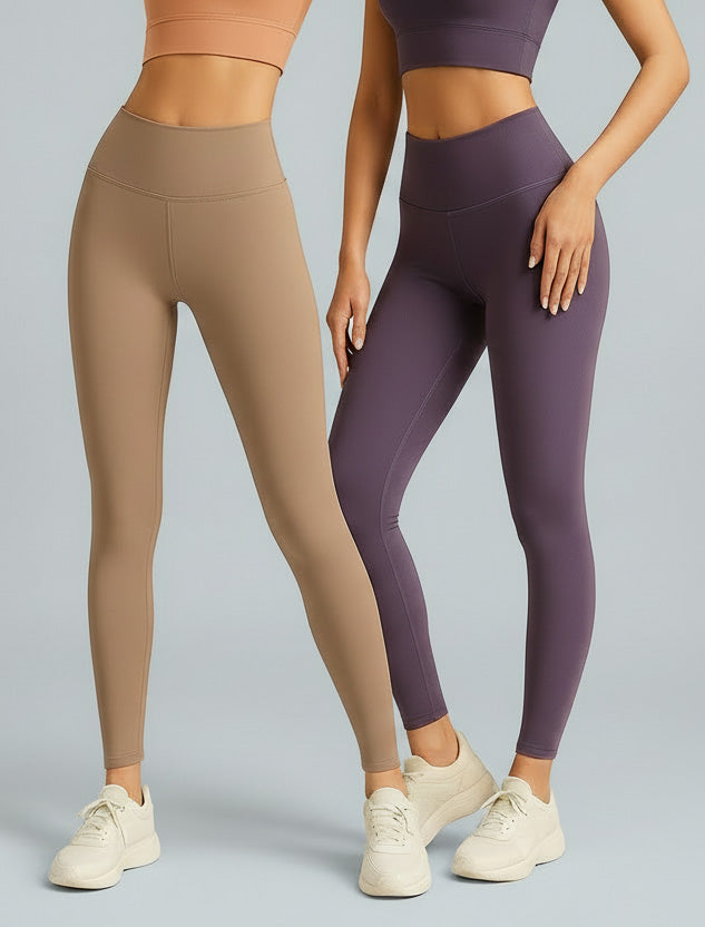 Two people wearing beige and purple leggings on a gray background
